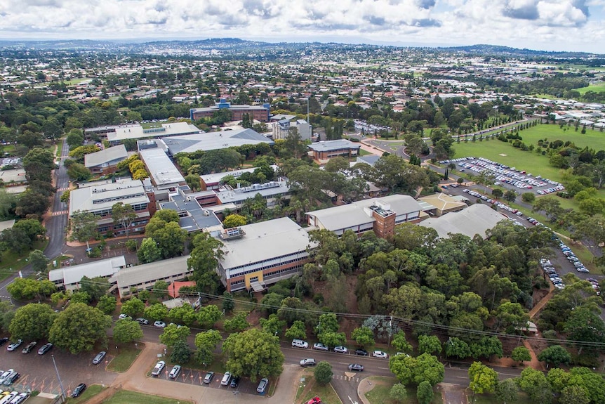 Aerial of university campus with regional city in background