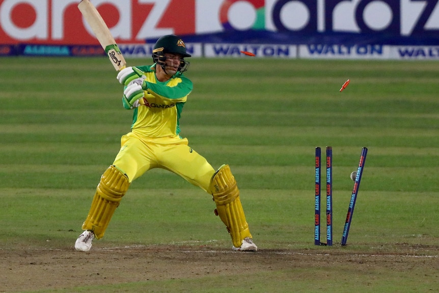 Bails fly after Alex Carey is bowled against Bangladesh.