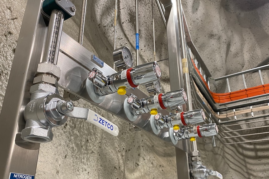 Scientific equipment inside the laboratory that resemble four taps in a row.