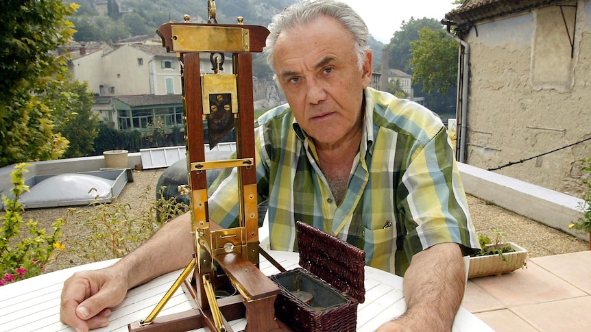 Fernand Meyssonnier with a miniature guillotine
