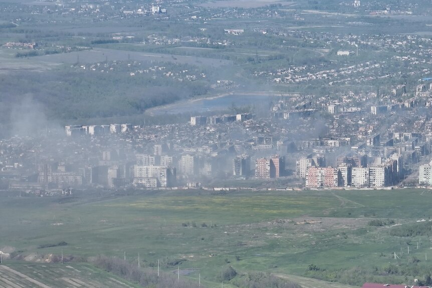 Smoke erupts following a shell explosion in the city Bakhmut.