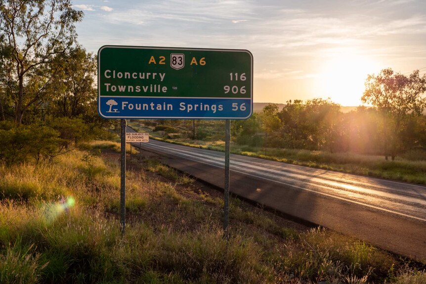 A photo of a green State highway sign, Cloncurry 116km, Townsville 906km.