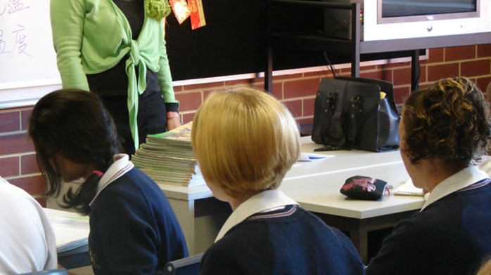 Students and teacher in classroom.