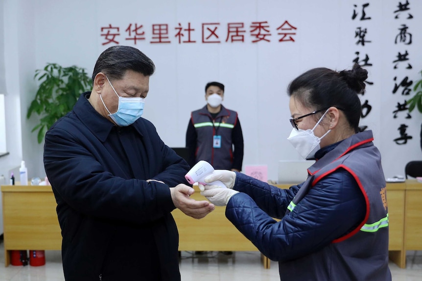 Xi Jinping wearing a face mask and getting his temperature checked as he visits  community health centre in Beijing.