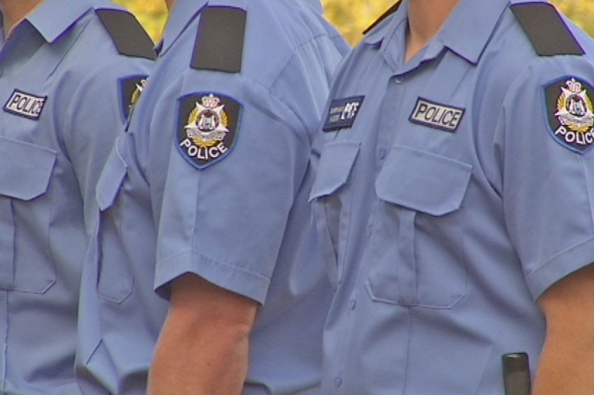Three unidentifiable WA police officers in uniform standing close by each other with their heads out of the frame.