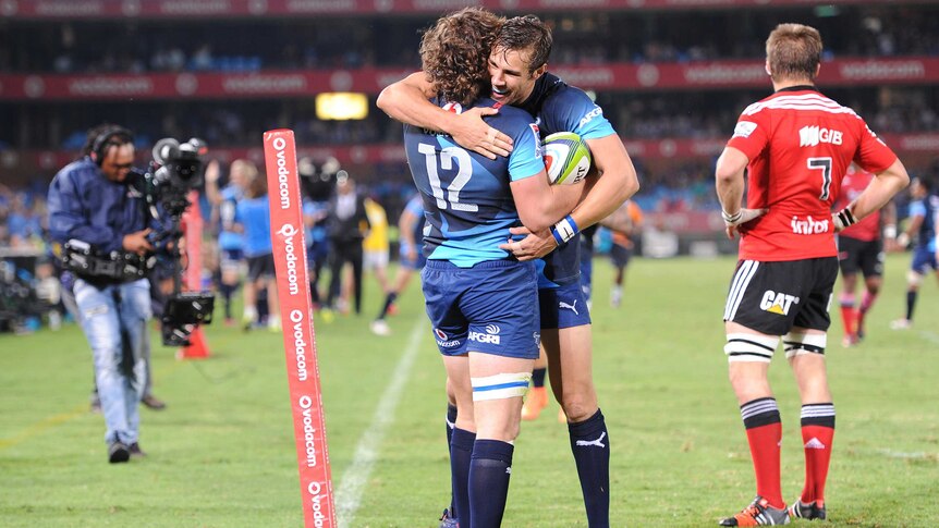 Burger Odendaal and JJ Engelbrecht celebrate a try for the Bulls against the Crusaders.