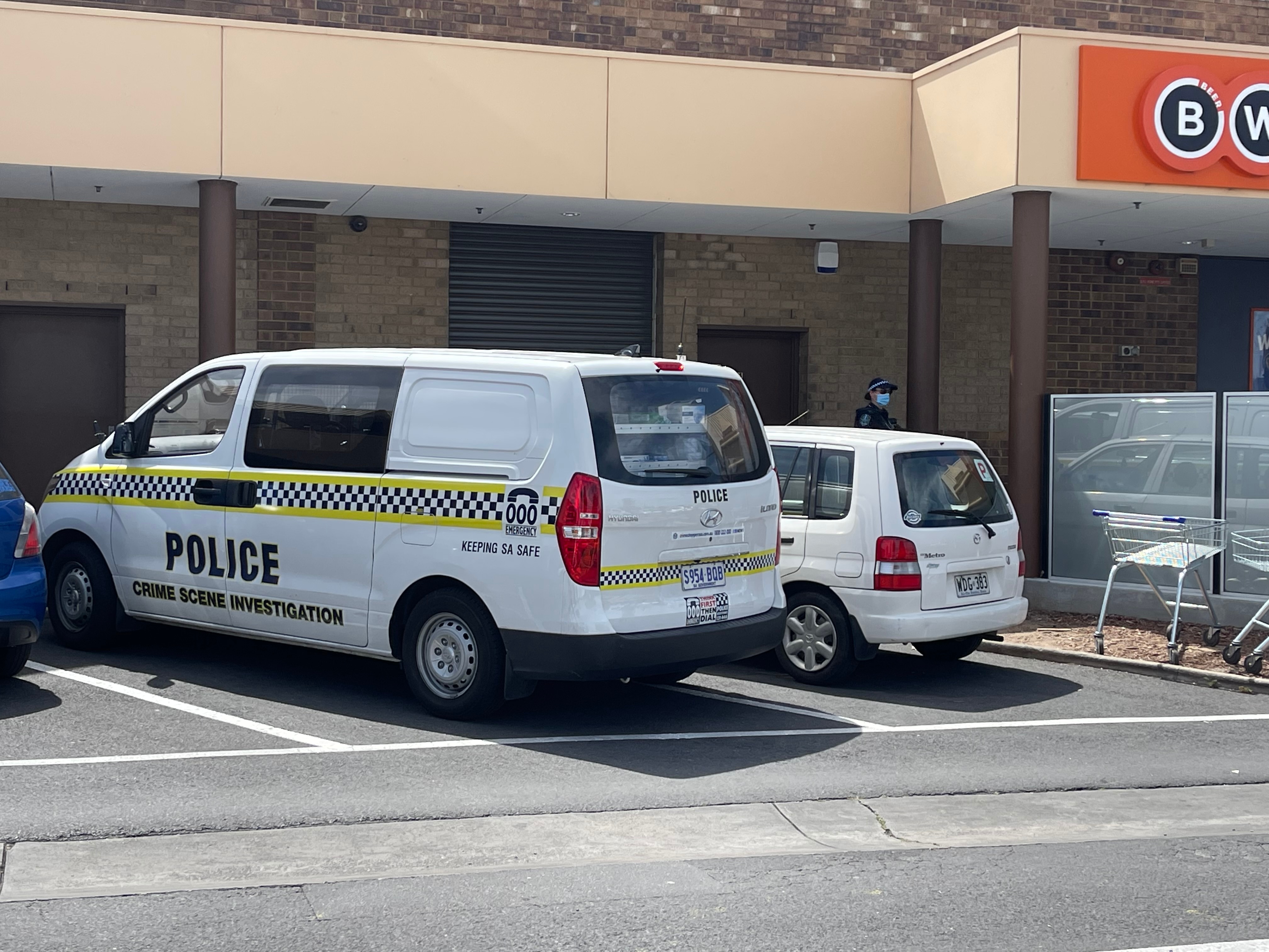 A police crime scene investigation van parked in a shopping centre car park