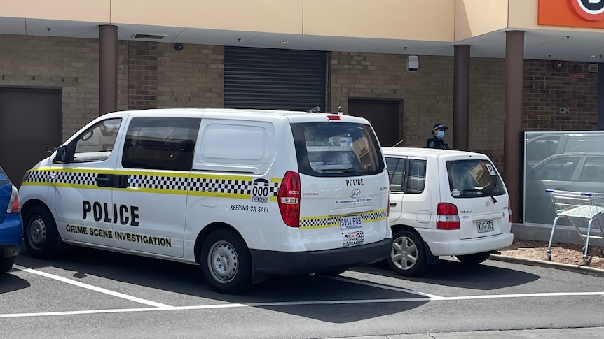 A police crime scene investigation van parked in a shopping centre car park