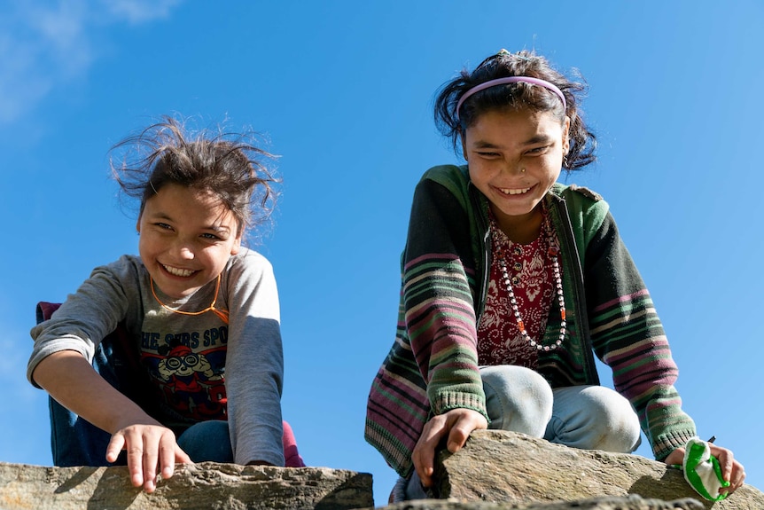 Devi and her sister on the roof.