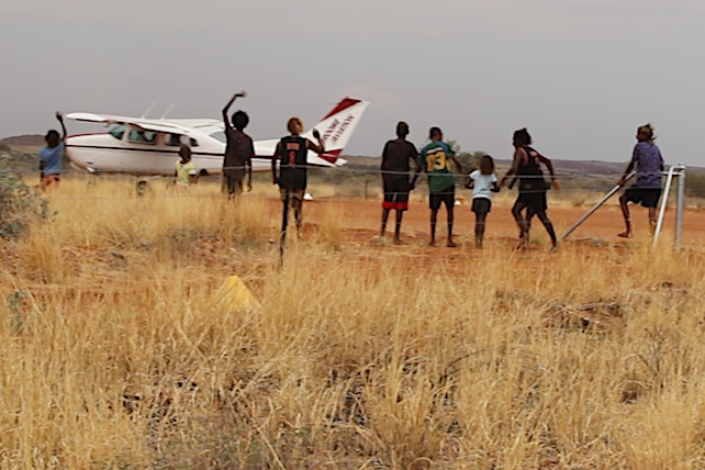 kids say goodbye to a plane