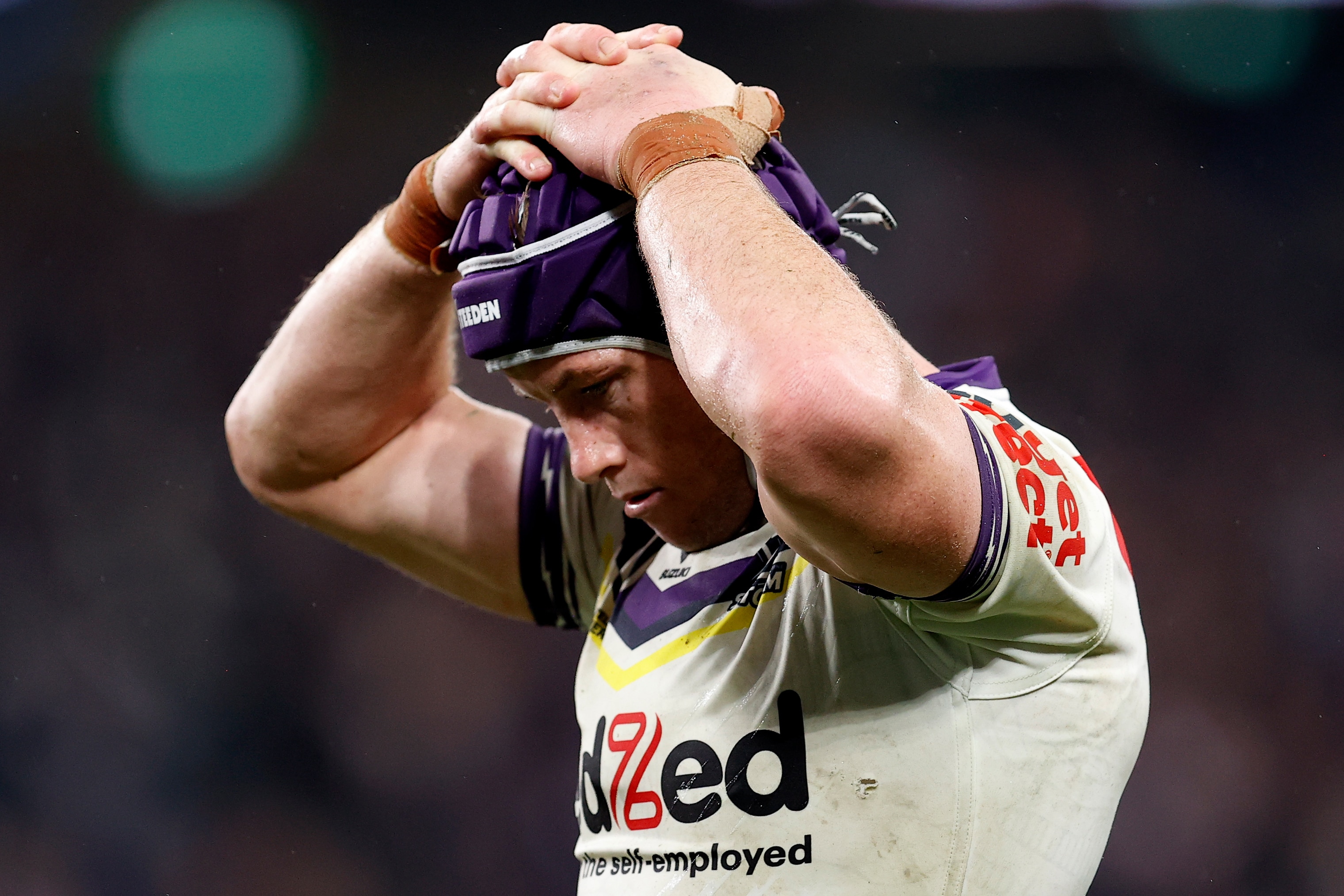A man looks despondent after suffering a hamstring injury in an NRL match