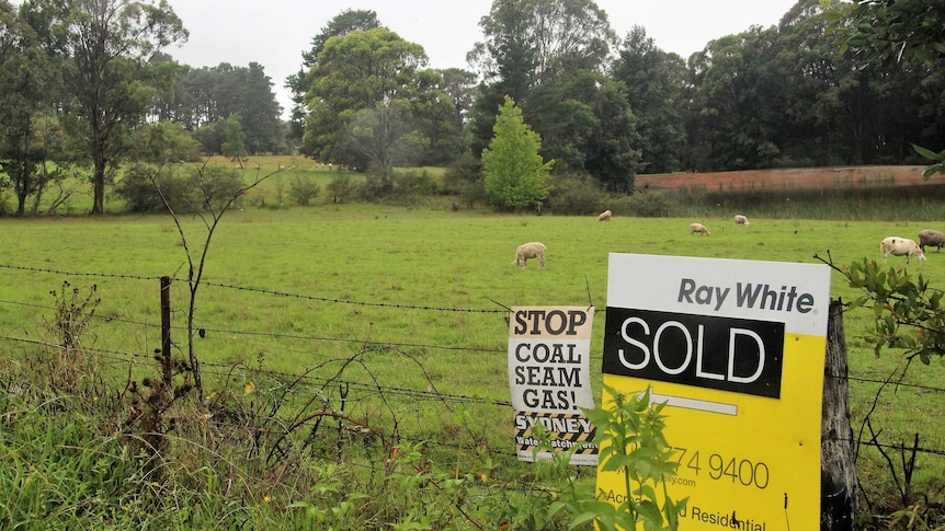 Rural land with a for sale sign