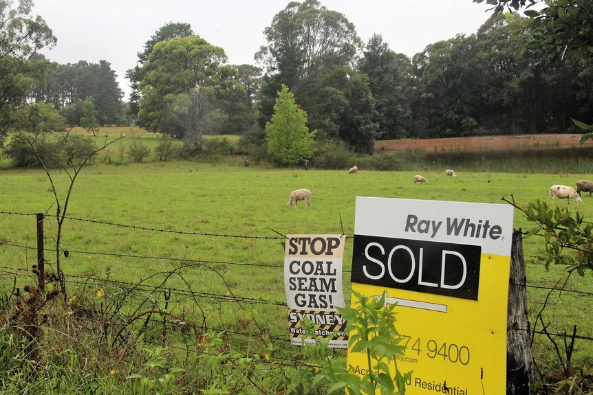 Rural land with a for sale sign