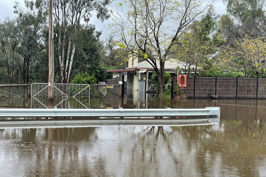 Water up to the front door of a house in flood.