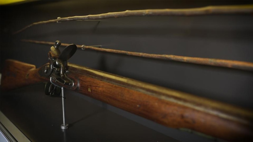 A rifle on a museum wall