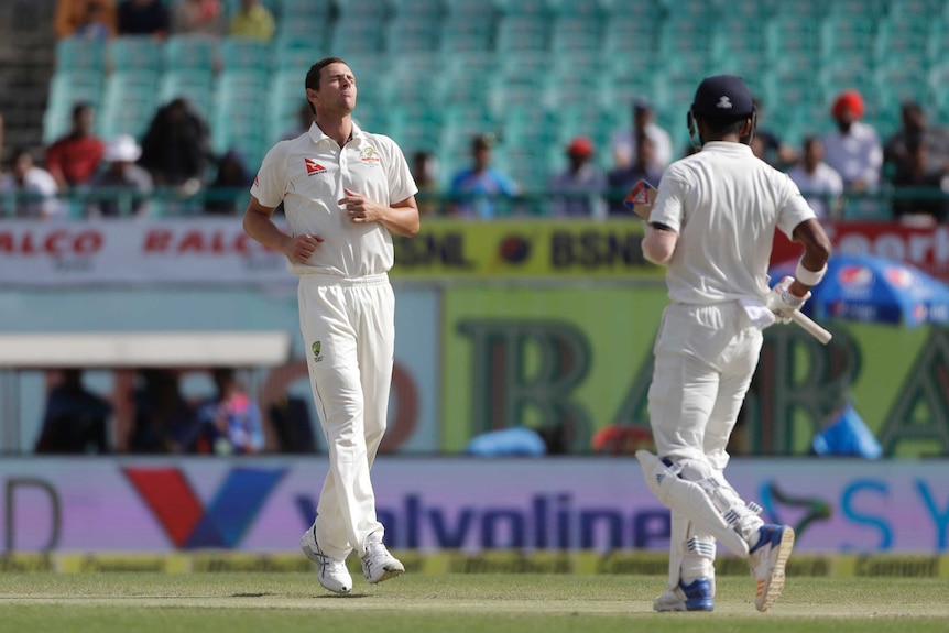 Australia fast bowler Josh Hazlewood (L) shows his frustration during day four in Dharmasala.
