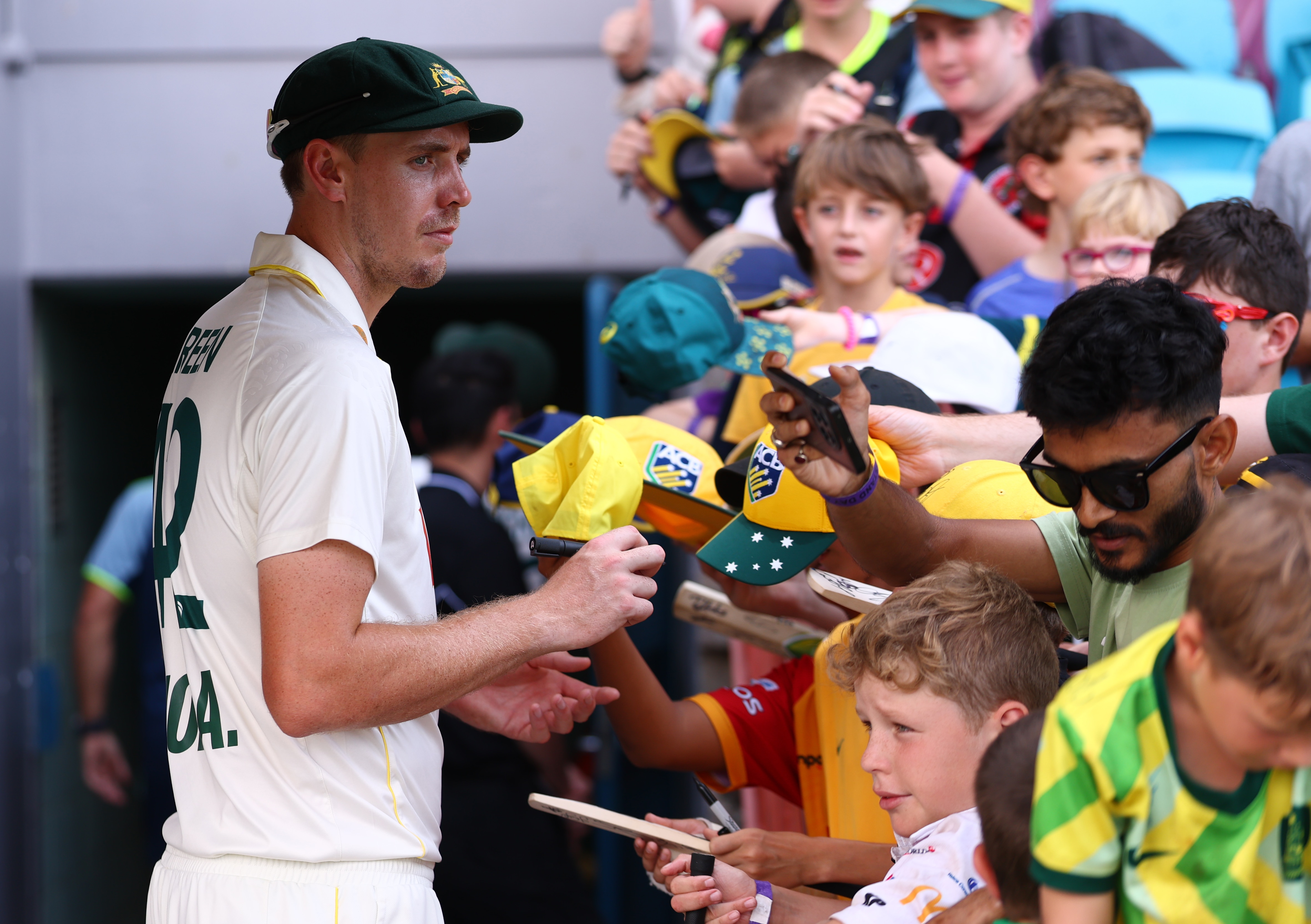 Cameron Green signs autographs after a Test against Bangladesh in Darwin.
