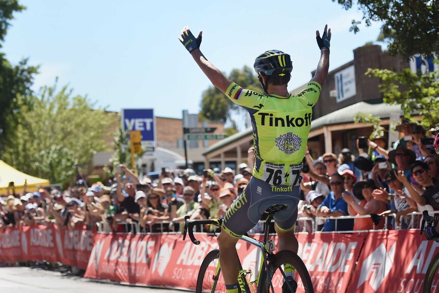 Jay McCarthy holds his arms high as the TDU stage 2 winner
