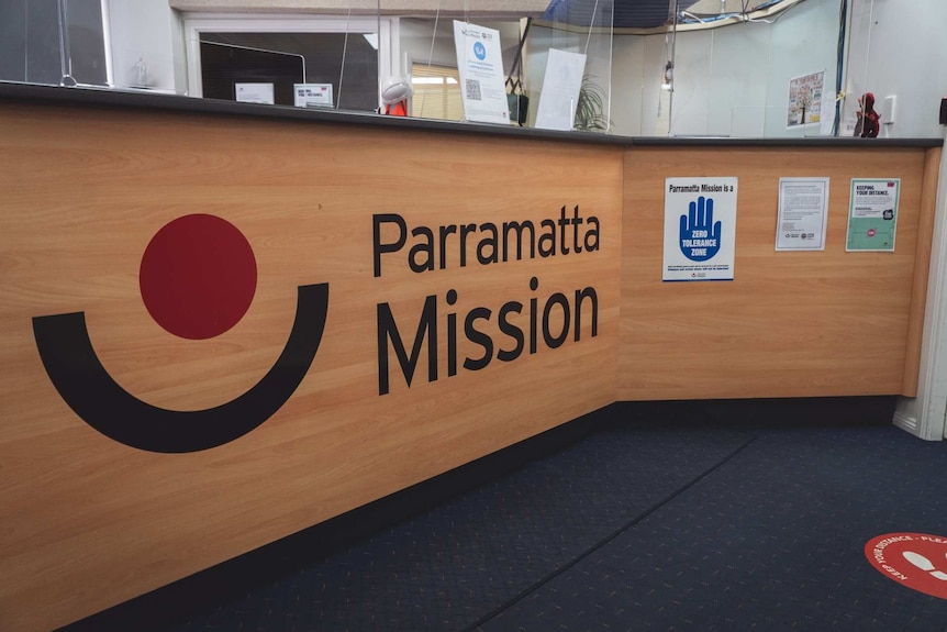 a front desk reception with the words parramatta mission emblazoned on it