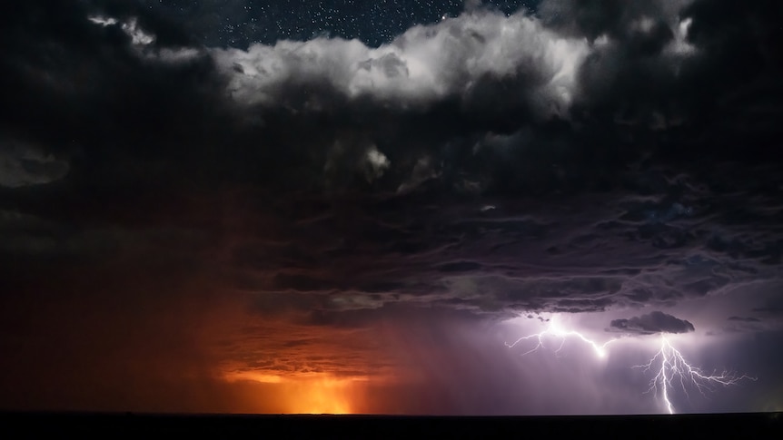 A photo of stars, clouds, fire and lightning bolts all in the same shot