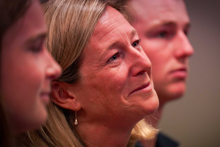 Nicola Hodgman looks on with tears in her eyes at press conference as her husband, Will resigns as Premier.