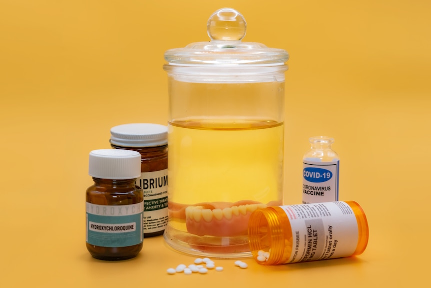 A photo of a jar with teeth and pill boxes.