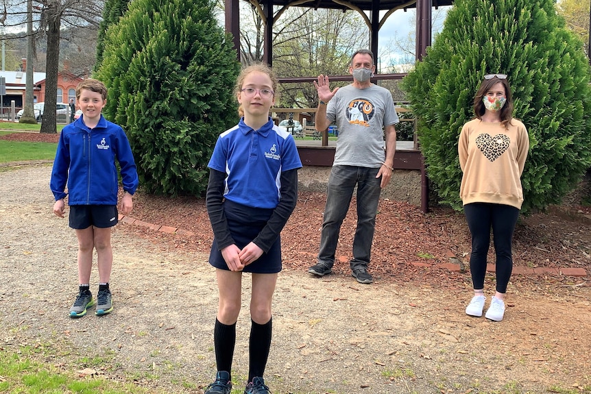 Students Flynn Graham and Ada Tracey, Scott Landell and Lauren Roberts stand in a park, socially distanced, looking at camera. 