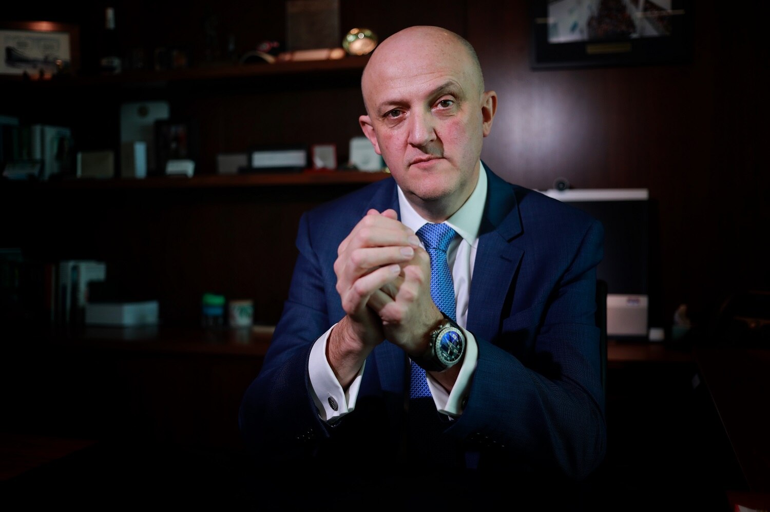 Mike Burgess in a dark office.