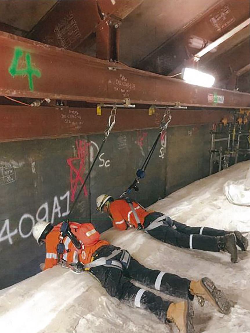 A photo of investigators using the safety system within the tank.