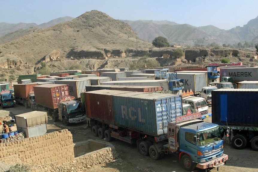 Trucks carrying NATO supplies park at Pakistan's Torkham border crossing