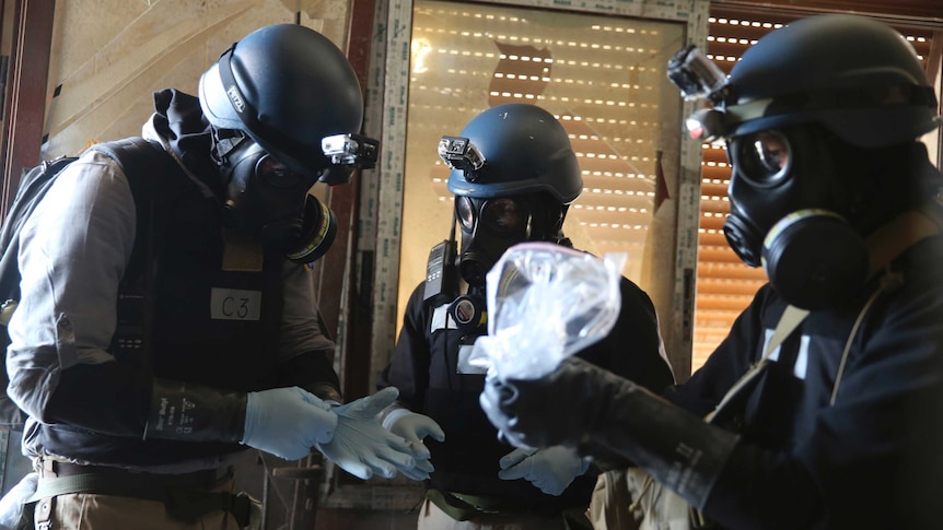 UN experts with samples from one of the sites of an alleged chemical weapons attack in Syria.