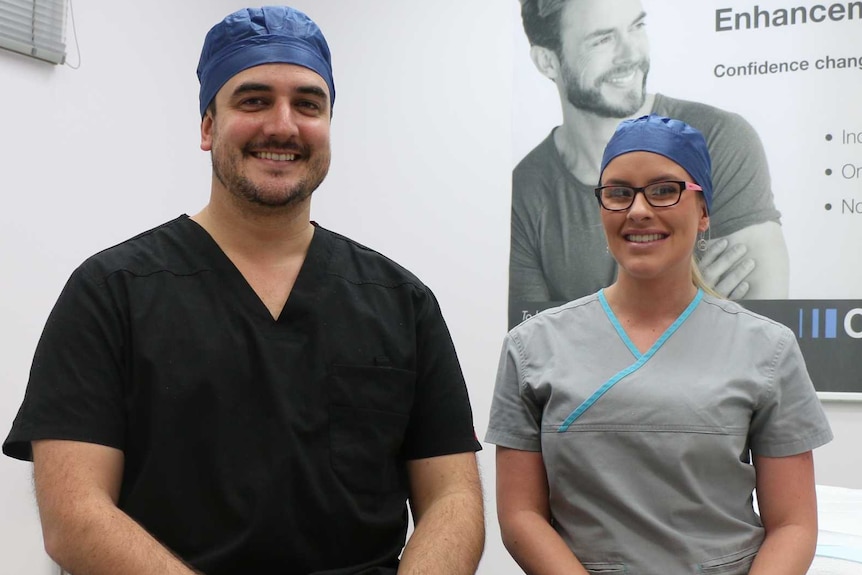 Dr Gavin Scriven and nurse Madeline Firkins sitting on a hospital bed