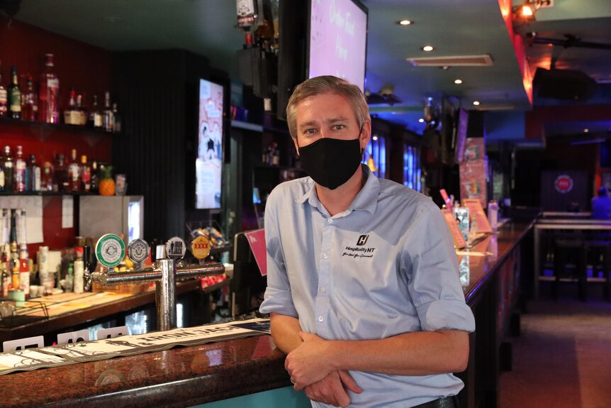Alex Bruce wears a mask in a bar. 