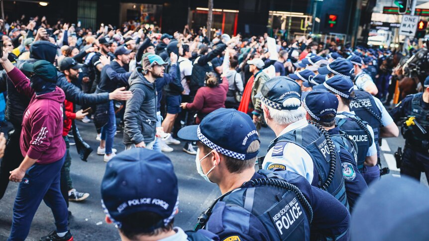 angry people standing in front of police