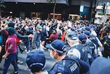 angry people standing in front of police