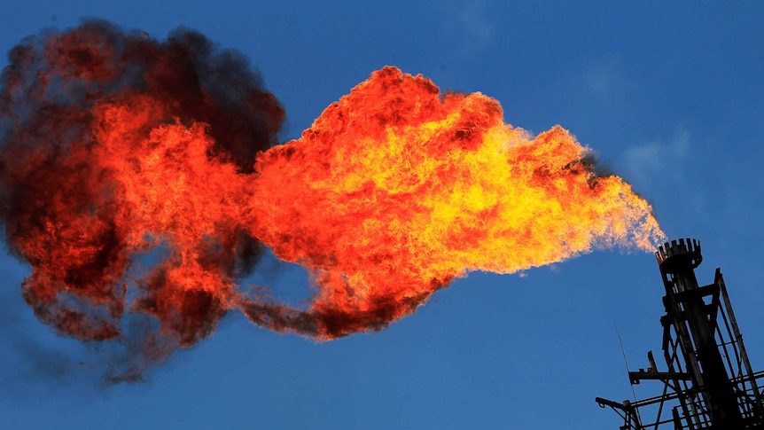 An LNG flare flames out from a stack.