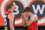 A player mimics crying as a sledge to another AFL player during a match