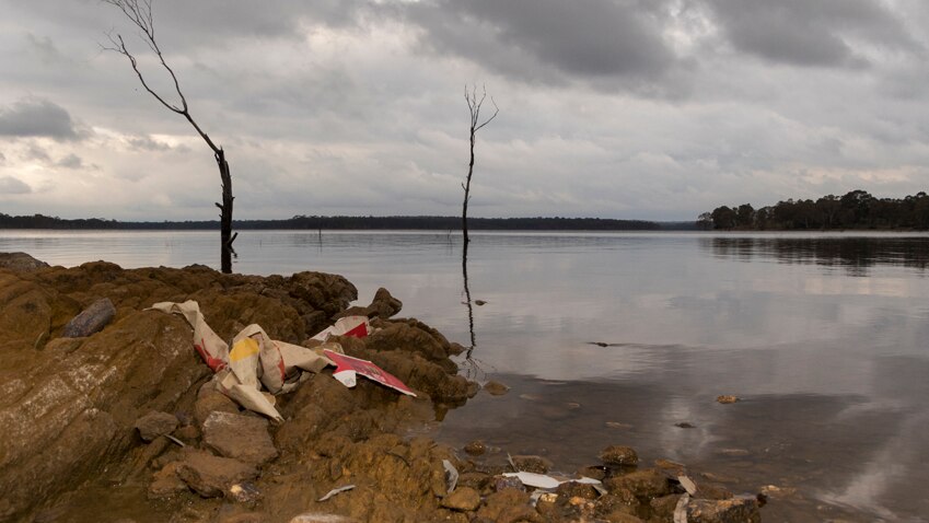 A landscape image of Lake Eppalock with litter in the foreground.