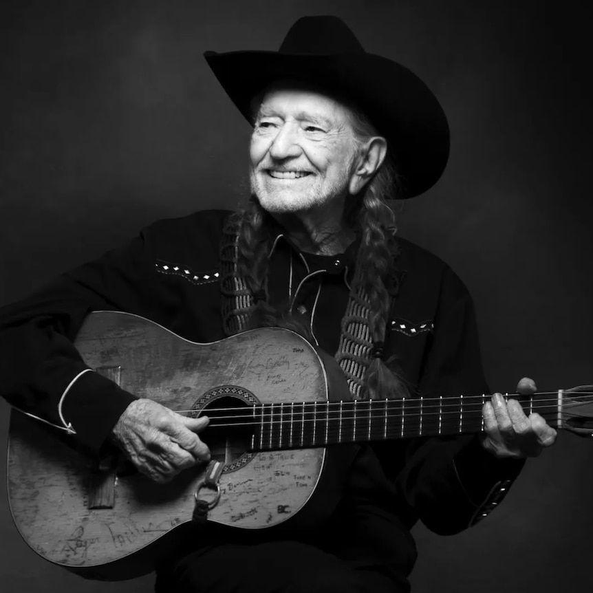 Country musician Willie Nelson black and white photo holding a guitar