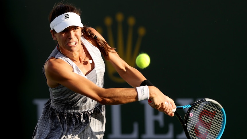 An Australian female professional tennis player prepares to play a backhand in Indian Wells.