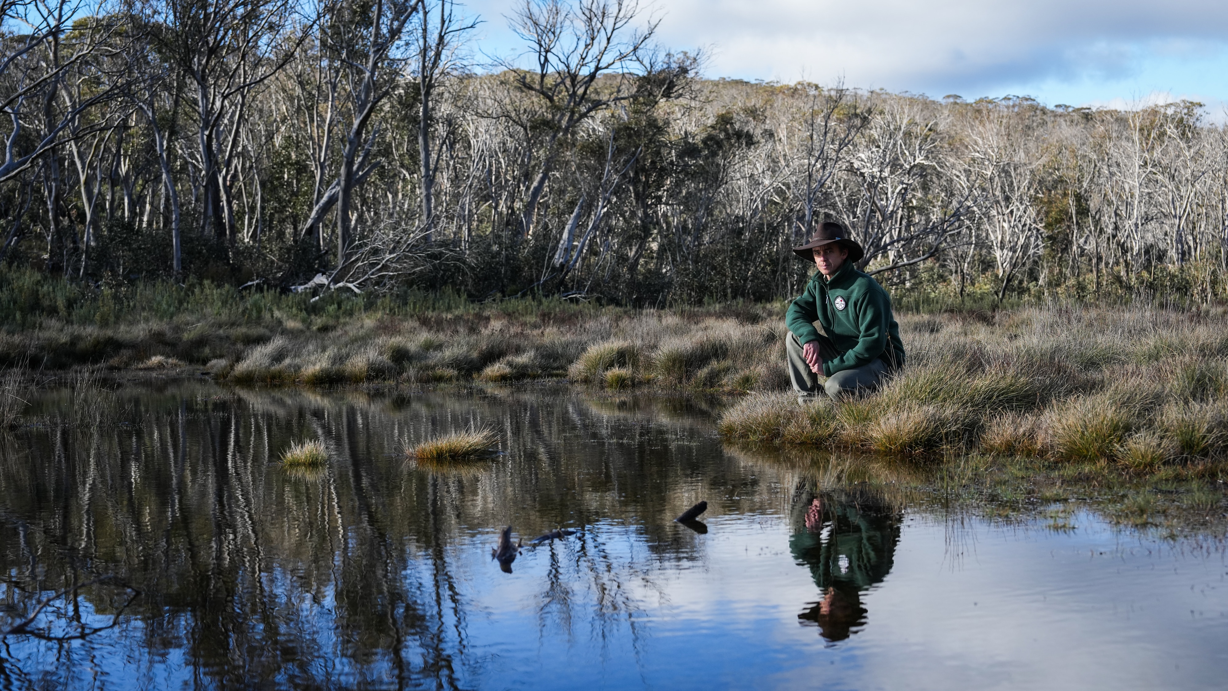 A man beside a pristine river.