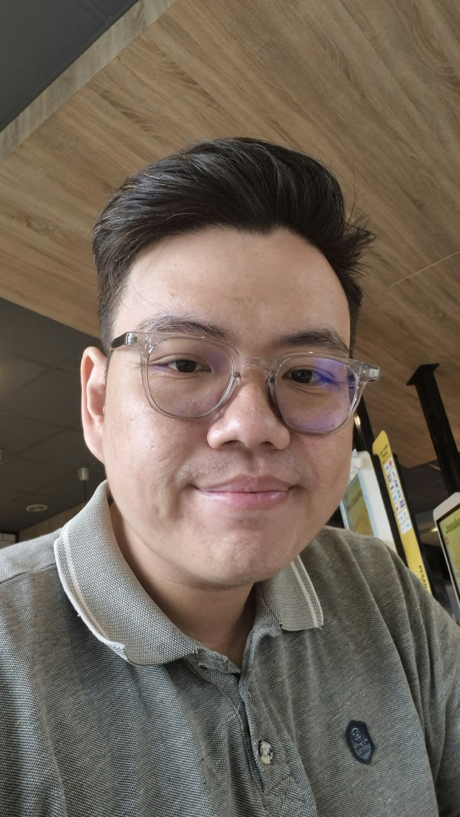 A man with glasses smile on camera