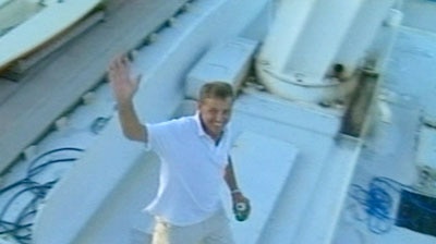A happier Christopher Packer waves from his boat.