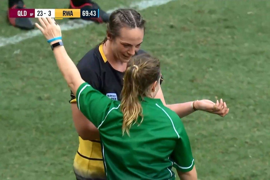 WA lock Rebecca Clough points to her arm while speaking to Super W referee Lara West.