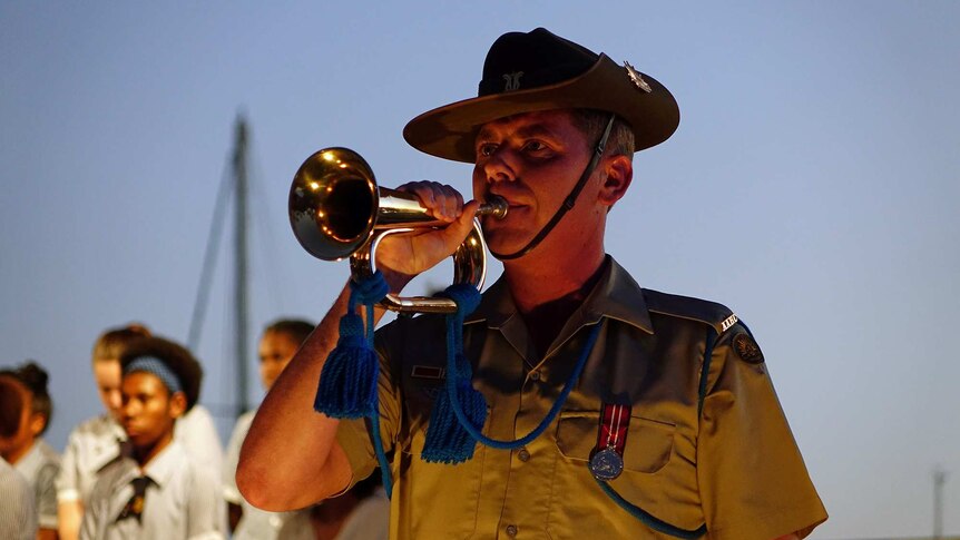 A lone bugler plays at the Anzac Day Dawn Service in Townsville on April 25, 2018.