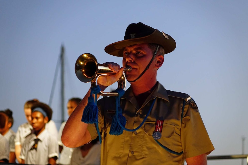 A lone bugler plays at the Anzac Day Dawn Service in Townsville on April 25, 2018.