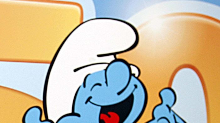 A Smurf dances and smiles