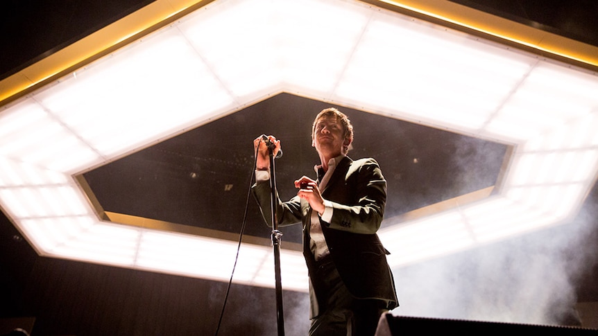 Arctic Monkeys frontman Alex Turner surveys the crowd at their Rod Laver Arena show in Melbourne, February 2019