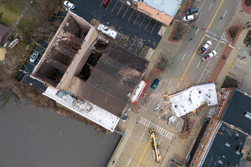 A view from above of a building with large holes in it roof from where it has collapsed.