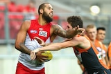 Sydney's Lance Franklin clashes with GWS' Tomas Bugg in round one of the AFL